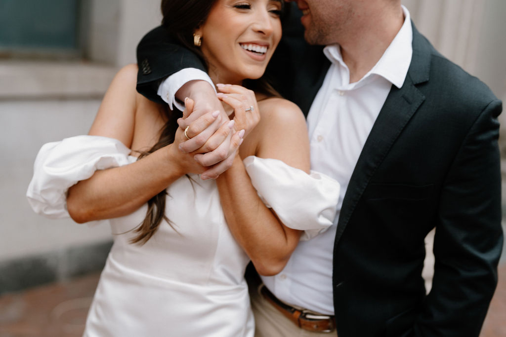 engaged couple hugging during urban photoshoot